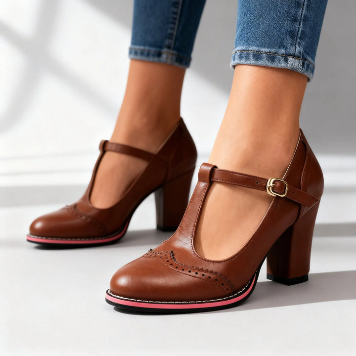 Brown leather T-bar brogue pump, angled view showing warm tone and brogue detailing