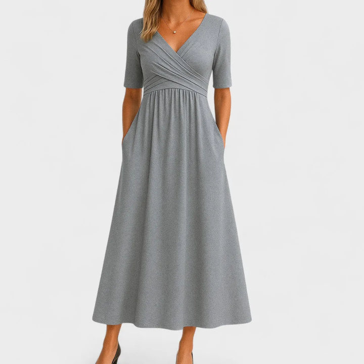 Gray wrap midi dress on model facing forward, featuring a V-neckline and tied waist