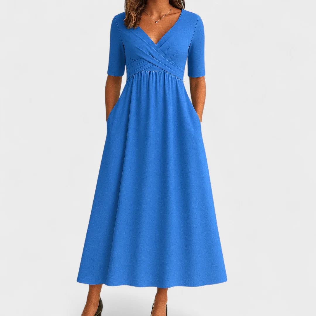 Light blue wrap midi dress close-up detail showing wrap bodice and tie closure