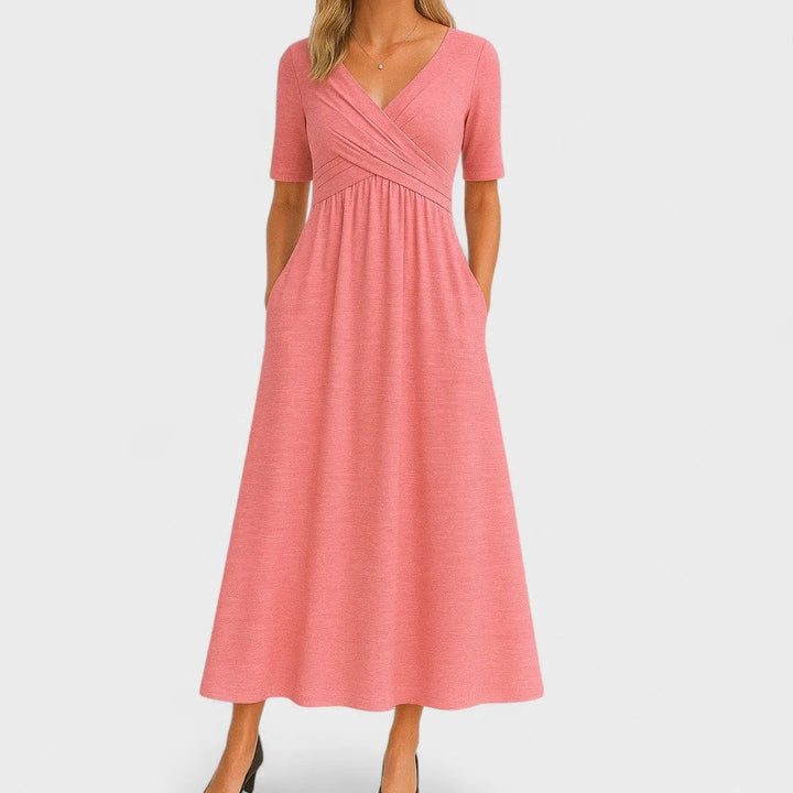 Pink wrap midi dress on model, featuring a V-neck wrap bodice and tied waist