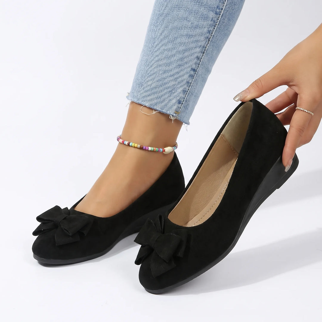 Black ballet flat with bow detail, front view