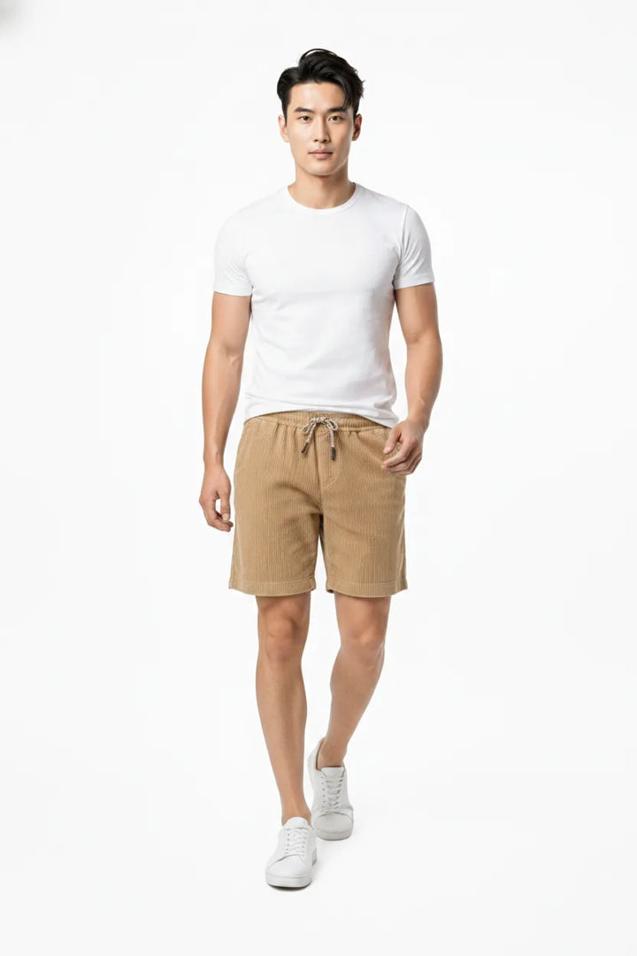 Khaki corduroy drawstring shorts on a model in natural movement
