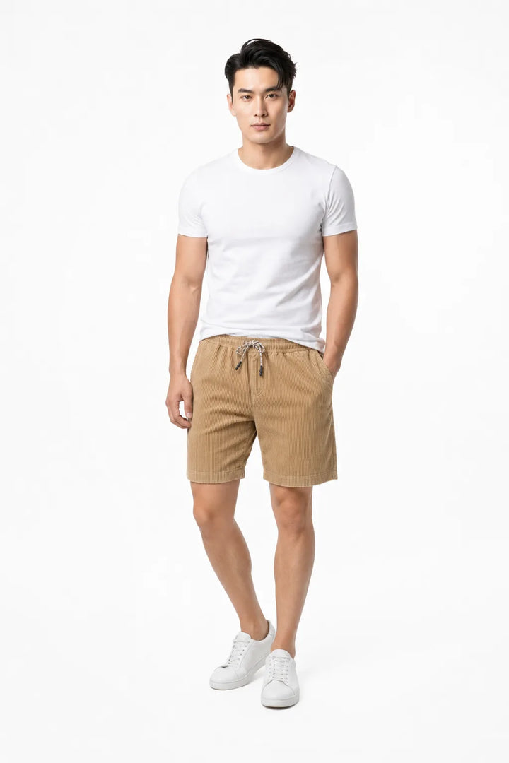 Khaki corduroy drawstring shorts on a model in a contrapposto stance
