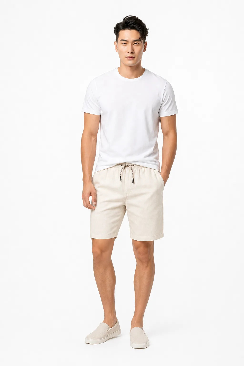 White corduroy drawstring shorts on a model in a contrapposto stance