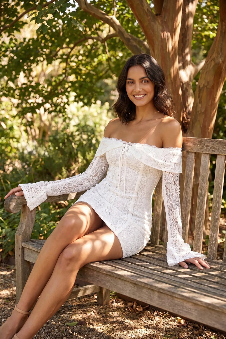 Model in white lace bell sleeve mini dress captured in outdoor lifestyle shot