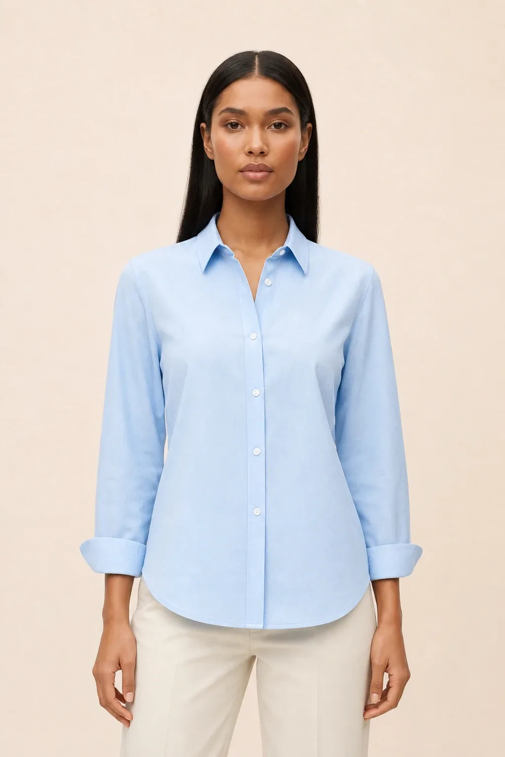 Blue relaxed button-down blouse on a model in a contrapposto stance