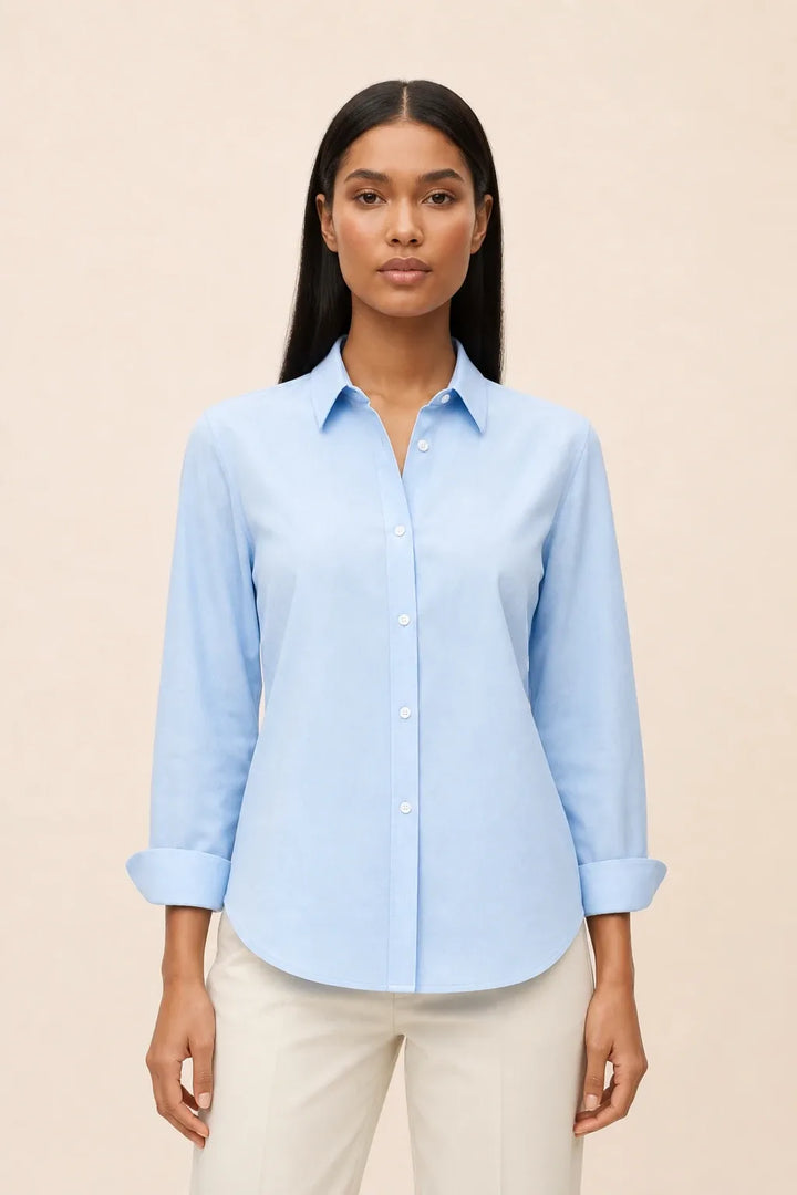 Blue relaxed button-down blouse on a model in a contrapposto stance