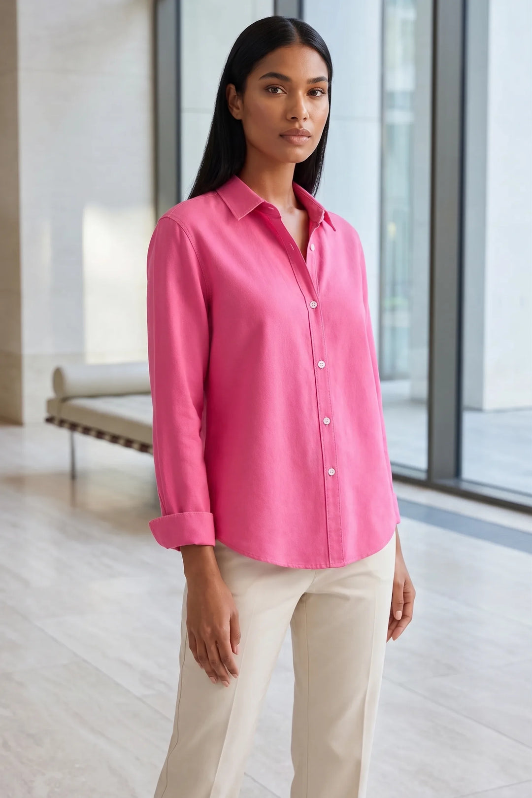 Model wearing a fuchsia relaxed button-down blouse in a lifestyle setting