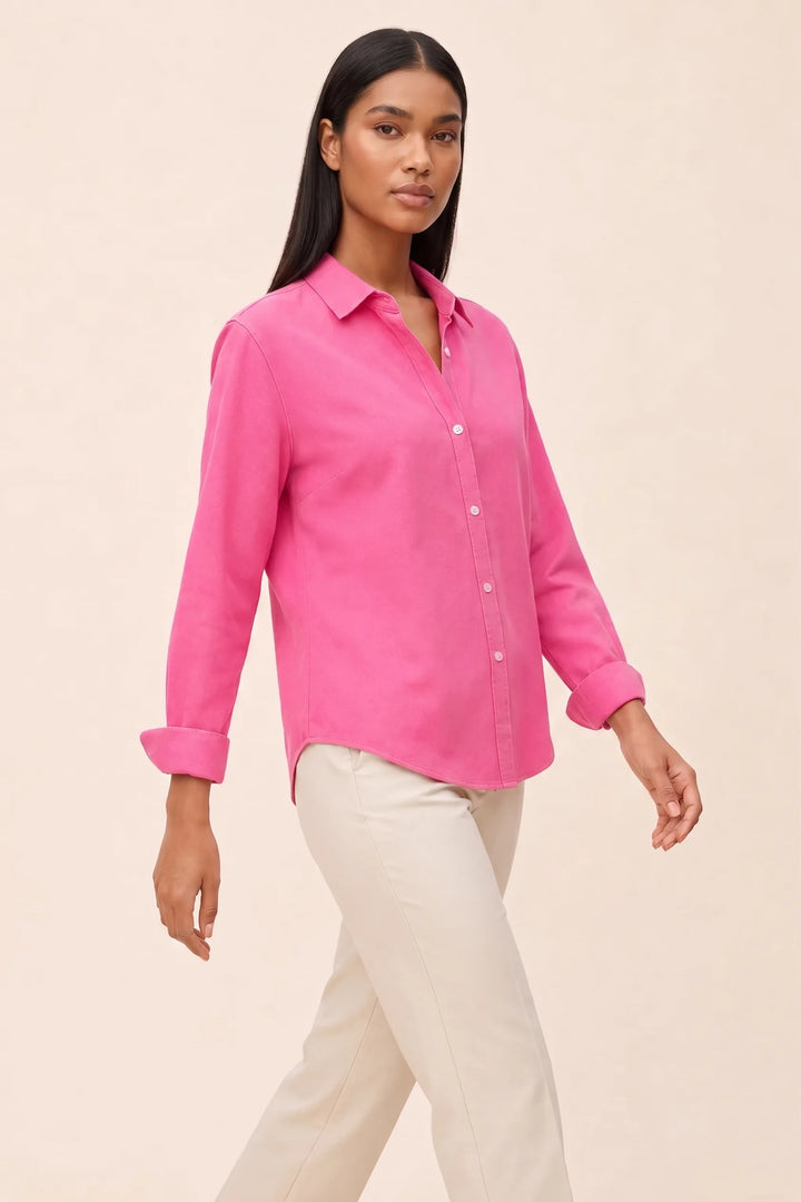 Fuchsia relaxed button-down blouse on a model in a three-quarter turn