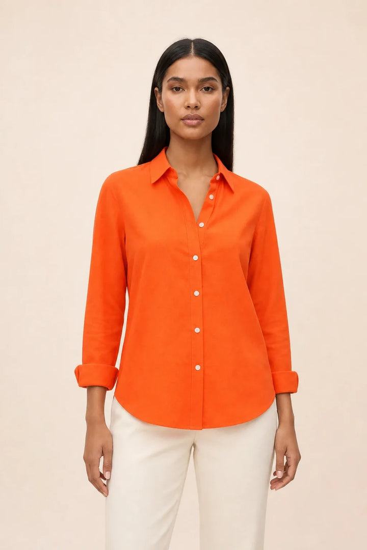 Orange relaxed button-down blouse on a model in a contrapposto stance
