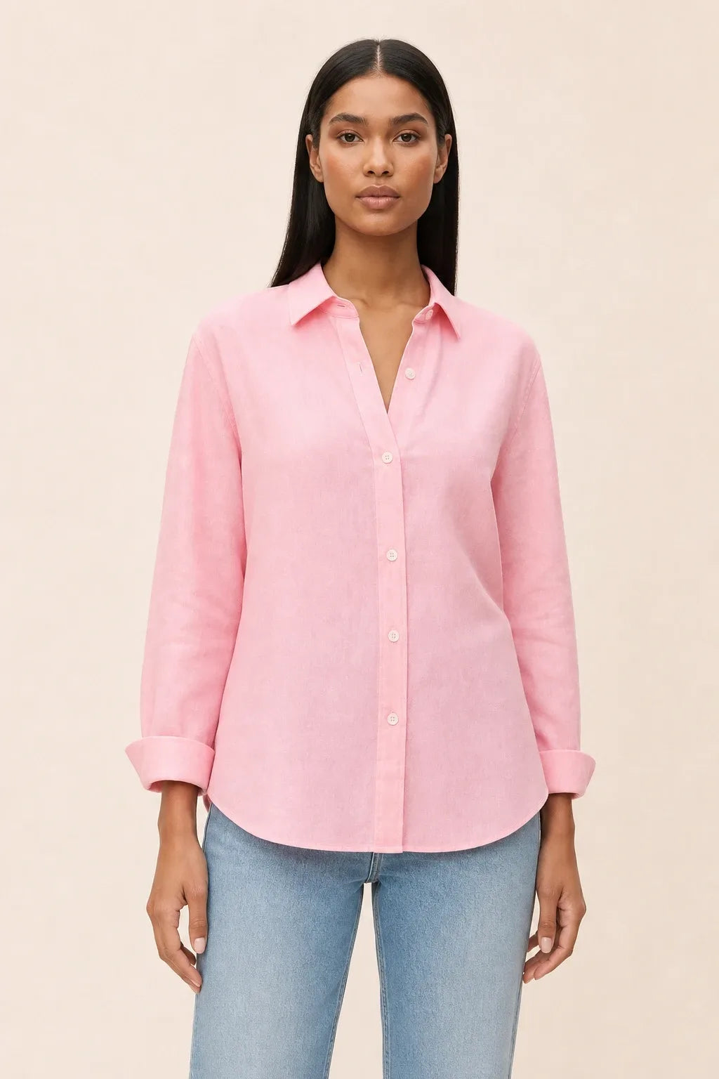 Pink relaxed button-down blouse on a model in a contrapposto stance