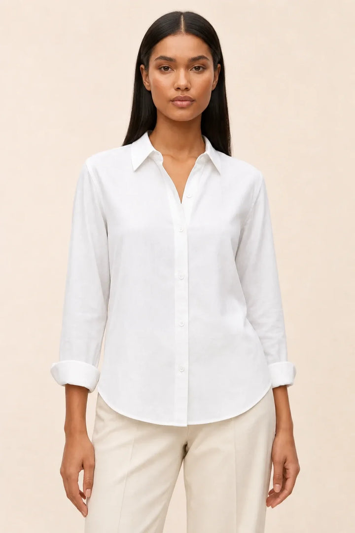 White relaxed button-down blouse on a model in a contrapposto stance