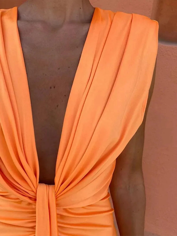 Close-up detail of the twist-front bodice on a blue maxi dress