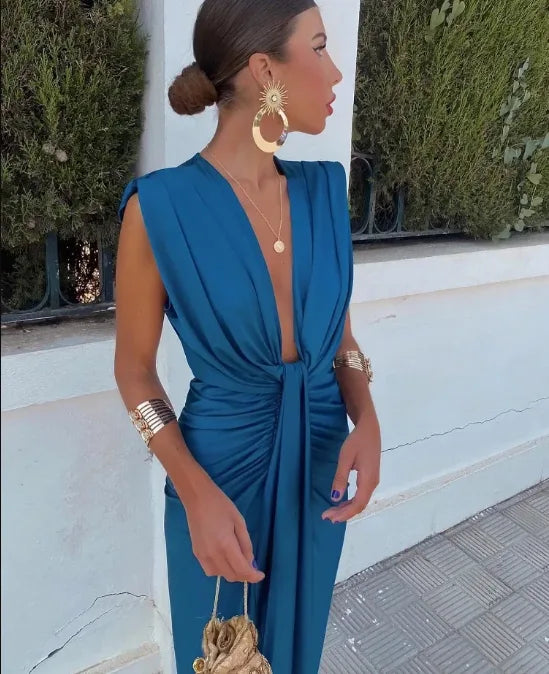 Woman wearing a blue twist-front maxi dress, facing forward