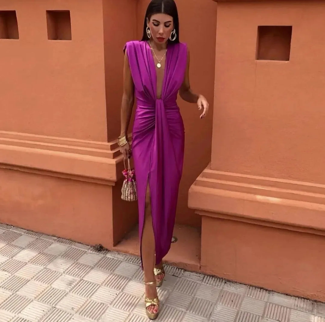 Woman wearing a fuchsia twist-front maxi dress, full-length view
