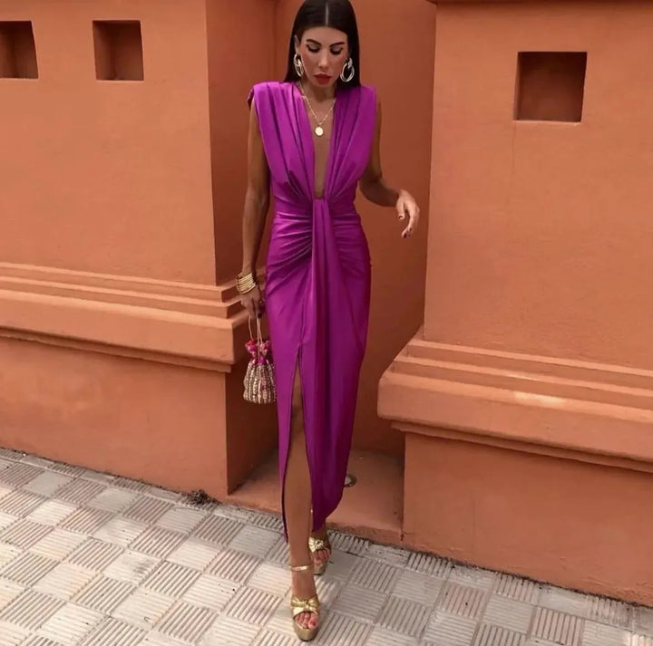 Woman wearing a fuchsia twist-front maxi dress, full-length view