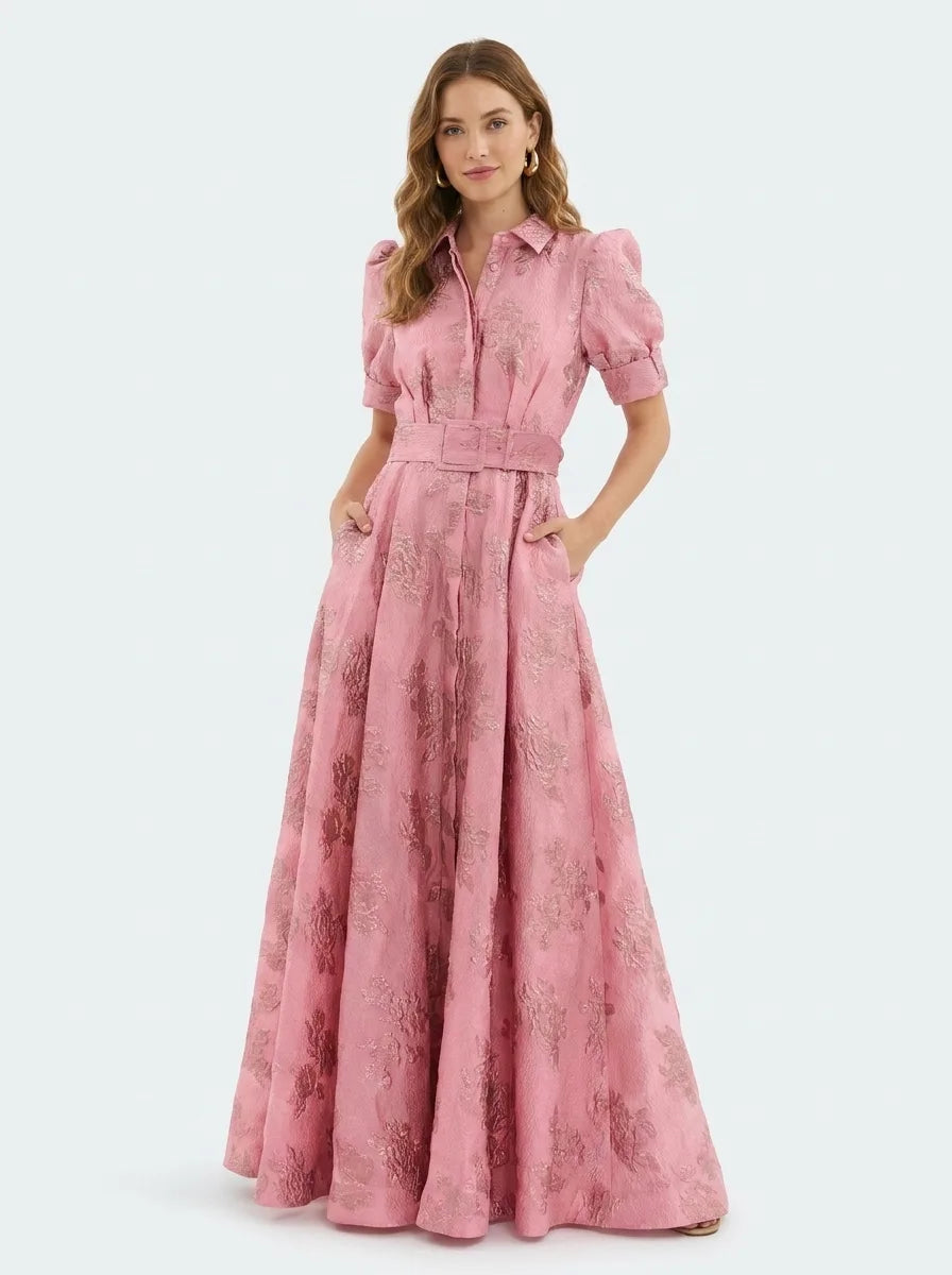 Woman at three-quarter turn in a beige jacquard maxi gown showing texture and fit