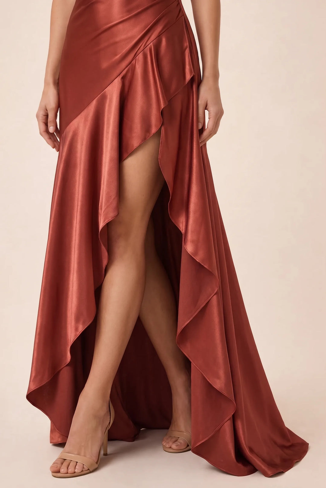 Close-up detail of ruching on brick red satin gown