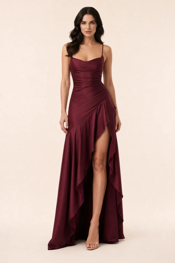 Burgundy ruched satin gown on model in contrapposto stance
