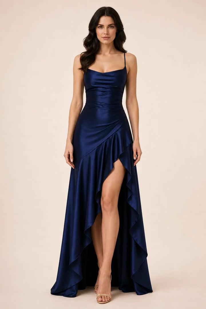 Navy blue ruched satin gown on model in contrapposto stance