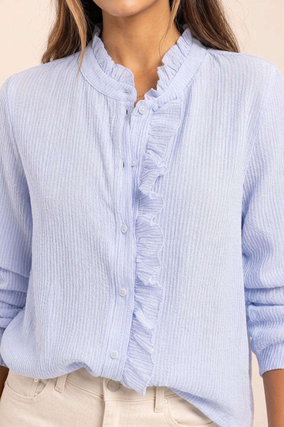 Close-up detail of blue ruffle front blouse
