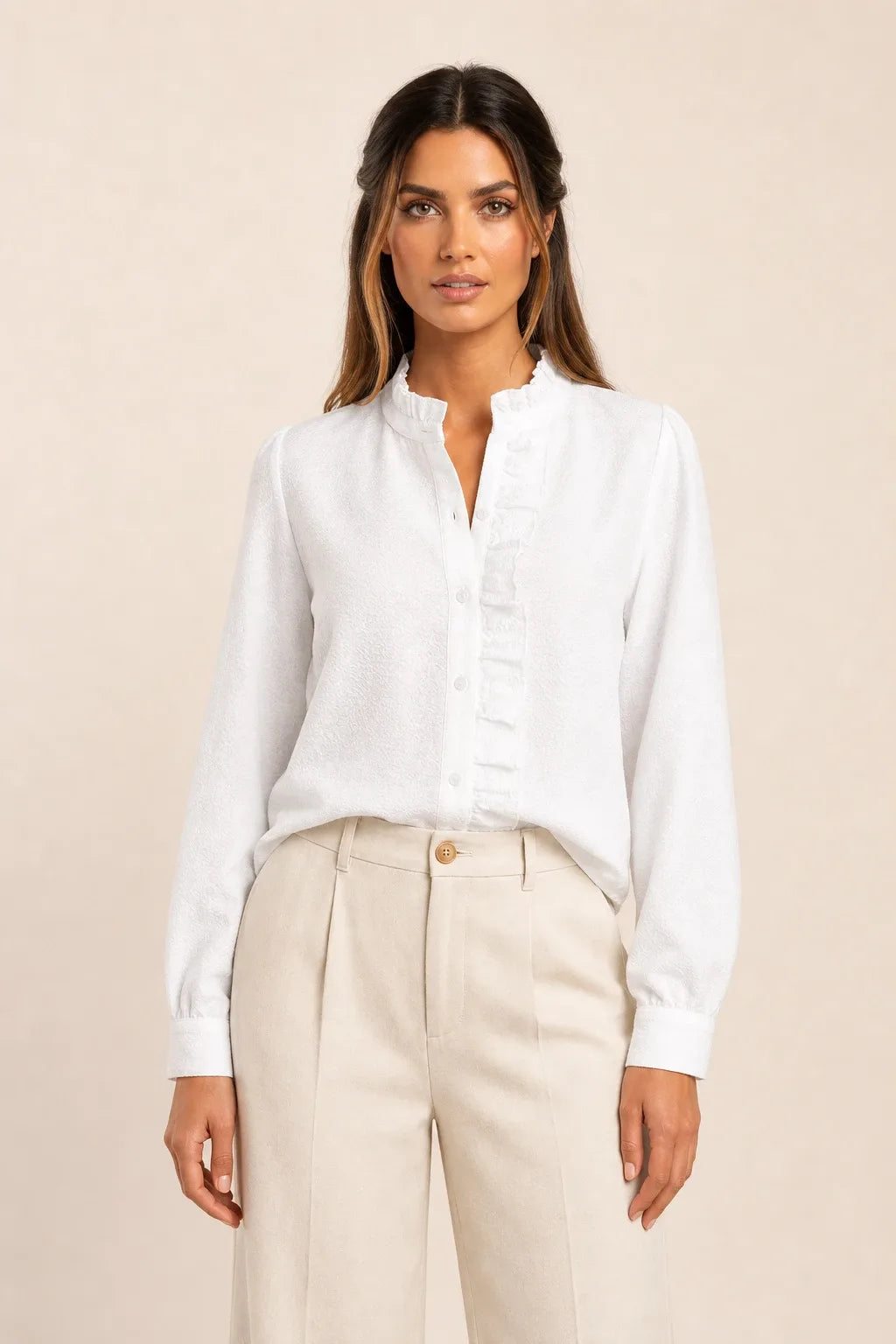 White ruffle front blouse on model in contrapposto stance