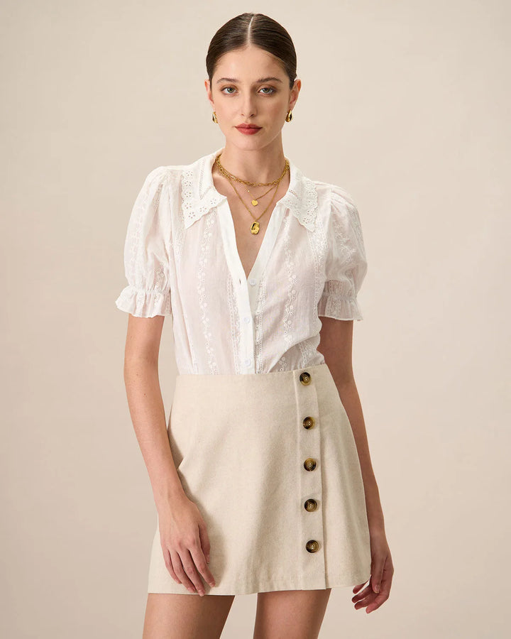 White broderie anglaise blouse on model facing forward, relaxed fit with delicate eyelet embroidery