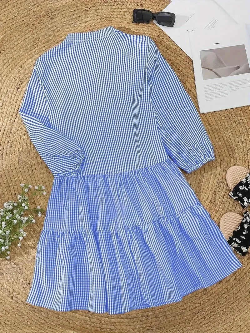 Woman styled in a pink gingham tiered mini dress, full-length front view