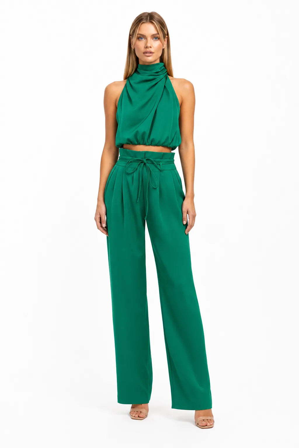 Green draped halter top and wide-leg trousers on a model in a contrapposto stance