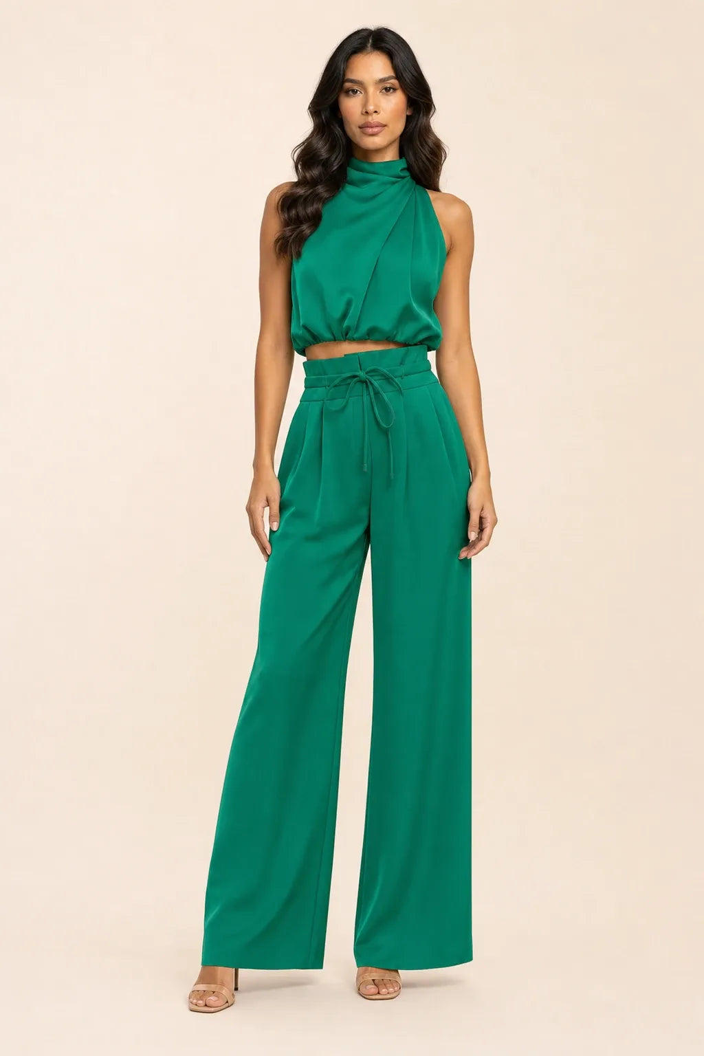 Green draped halter and wide-leg trousers on a model in a contrapposto stance