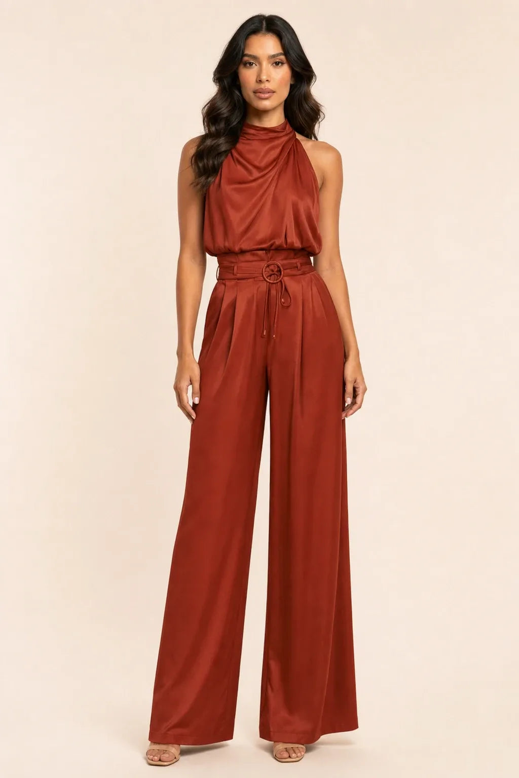 Rust draped halter and wide-leg trousers on a model in a contrapposto stance