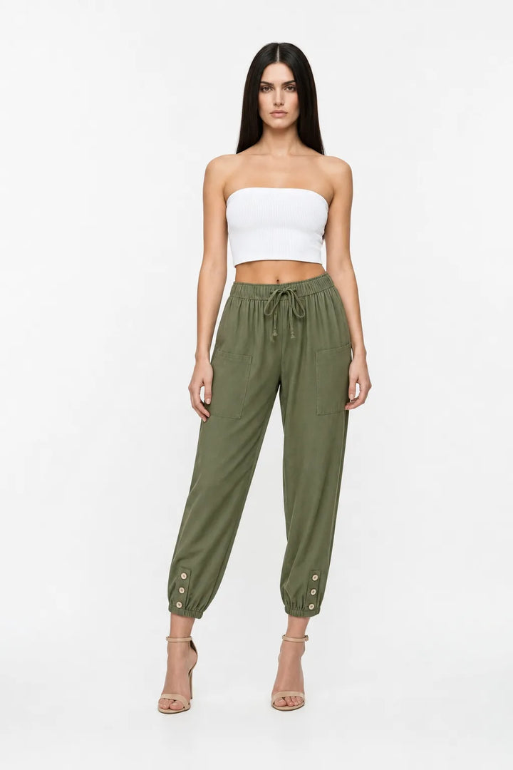 Army green drawstring jogger pants on a model in a contrapposto stance