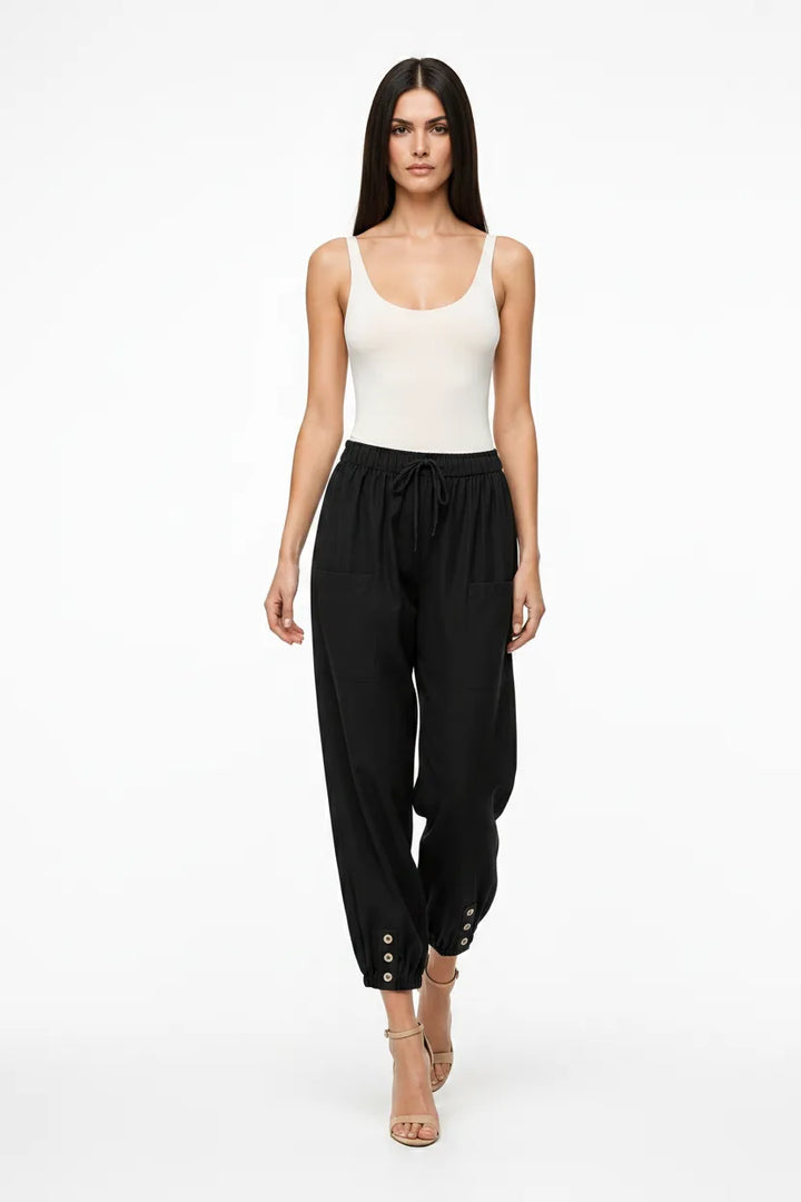 Black drawstring jogger pants on a model in natural movement