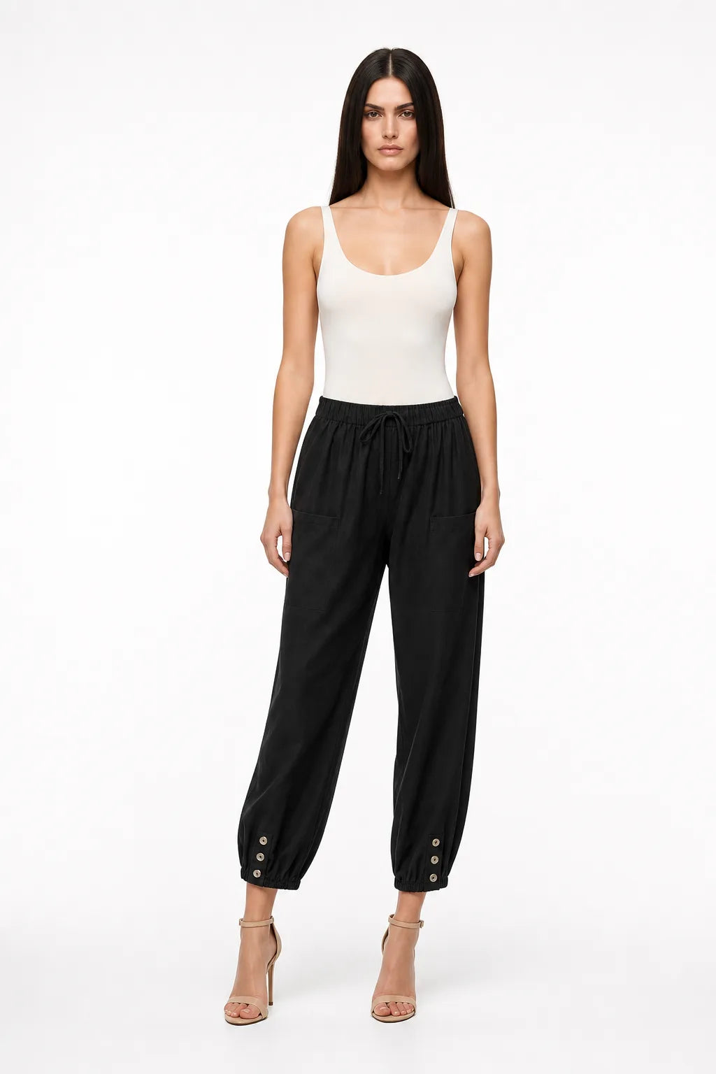 Black drawstring jogger pants on a model in a contrapposto stance
