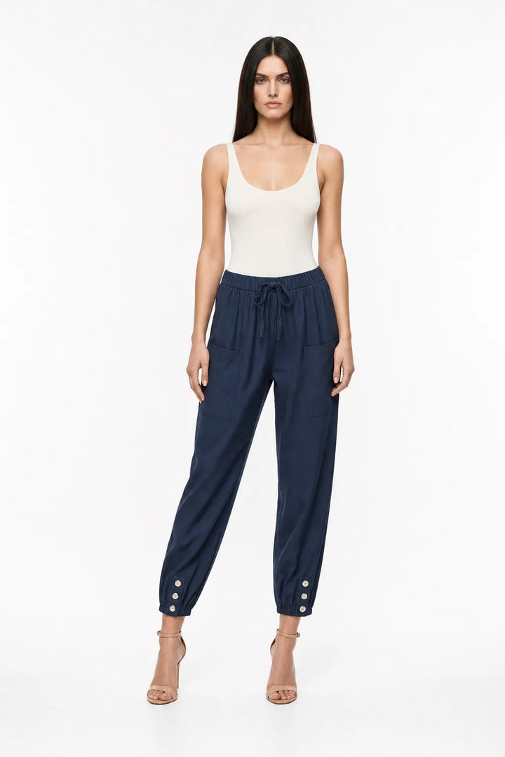 Navy blue drawstring jogger pants on a model in a contrapposto stance