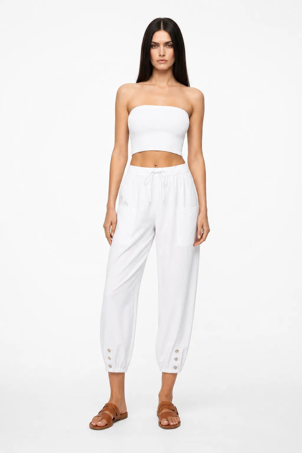 White drawstring jogger pants on a model in a contrapposto stance