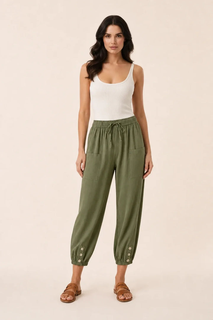 Army green drawstring jogger pants on a model in a contrapposto stance