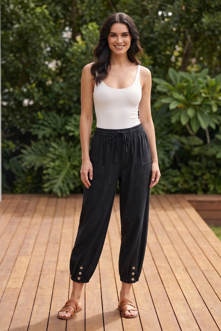 Model wearing black drawstring jogger pants in a casual lifestyle setting