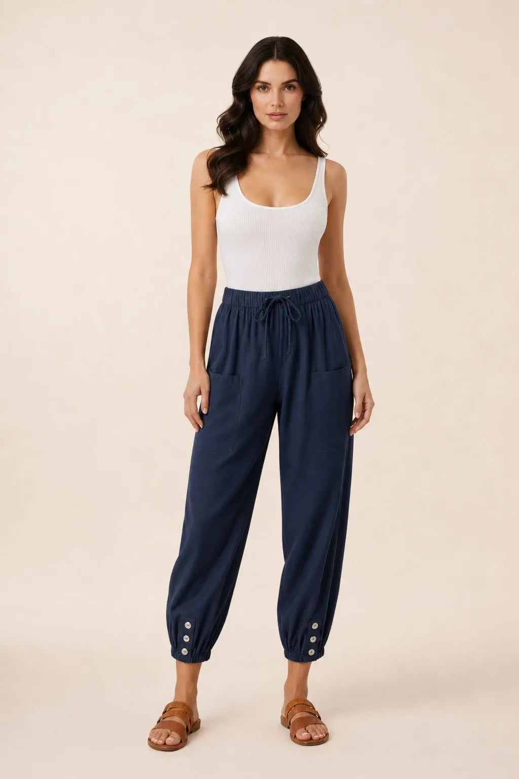 Navy blue drawstring jogger pants on a model in a contrapposto stance