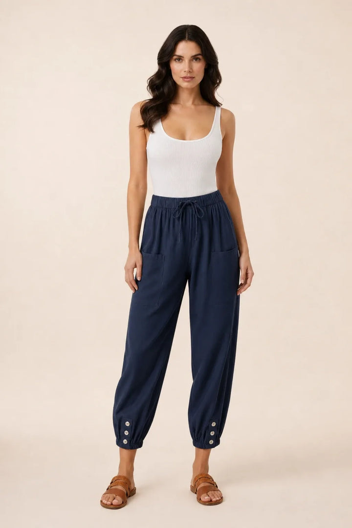 Navy blue drawstring jogger pants on a model in a contrapposto stance