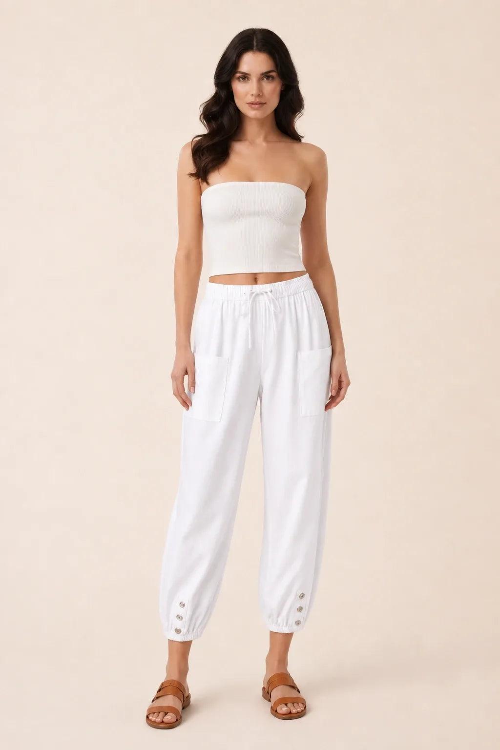 White drawstring jogger pants on a model in a contrapposto stance