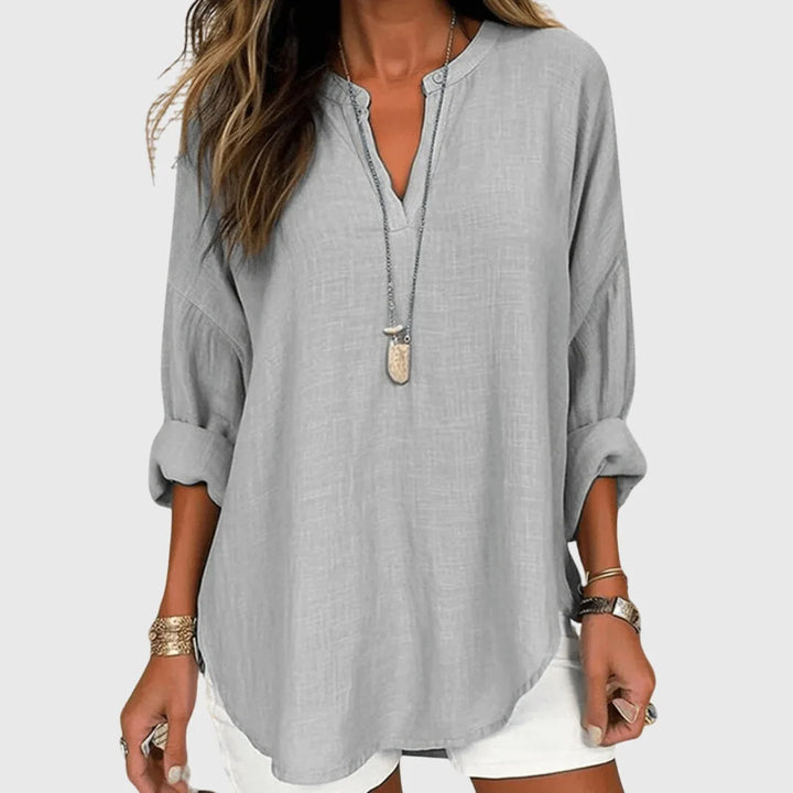 Gray v-neck tunic blouse on model