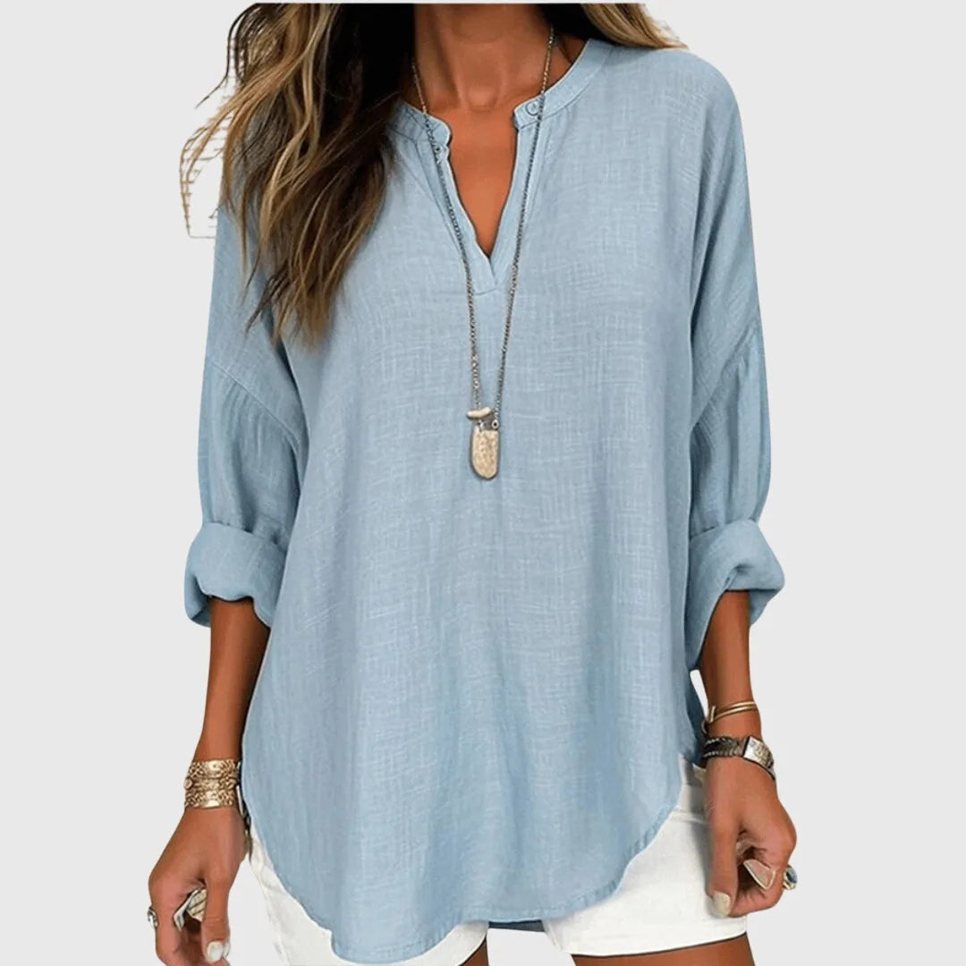 Light blue v-neck tunic blouse on model, front view