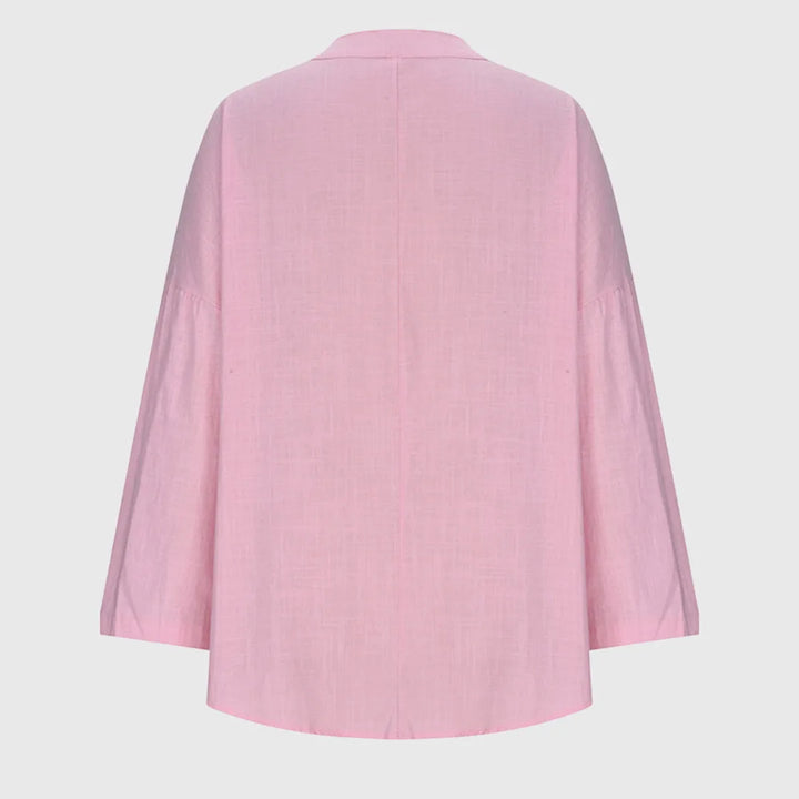 Light blue v-neck tunic blouse on model, alternate view