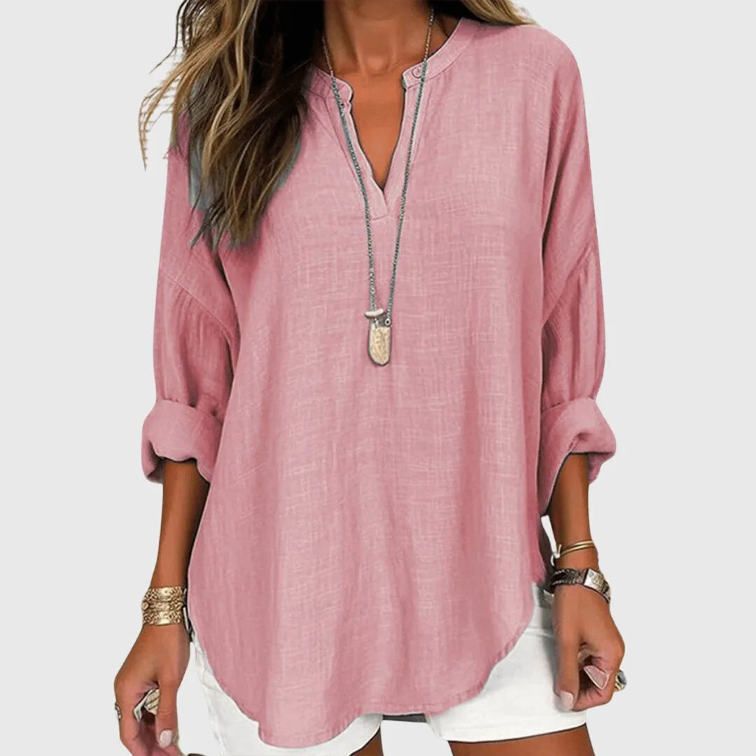 Pink v-neck tunic blouse close-up detail of fabric and neckline