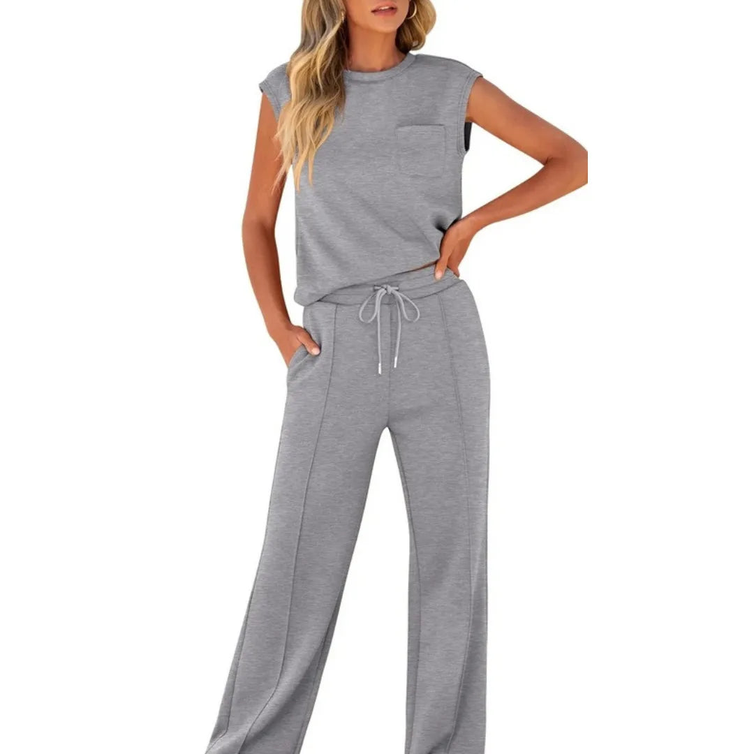 Gray cap sleeve top and coordinating trousers on standing model