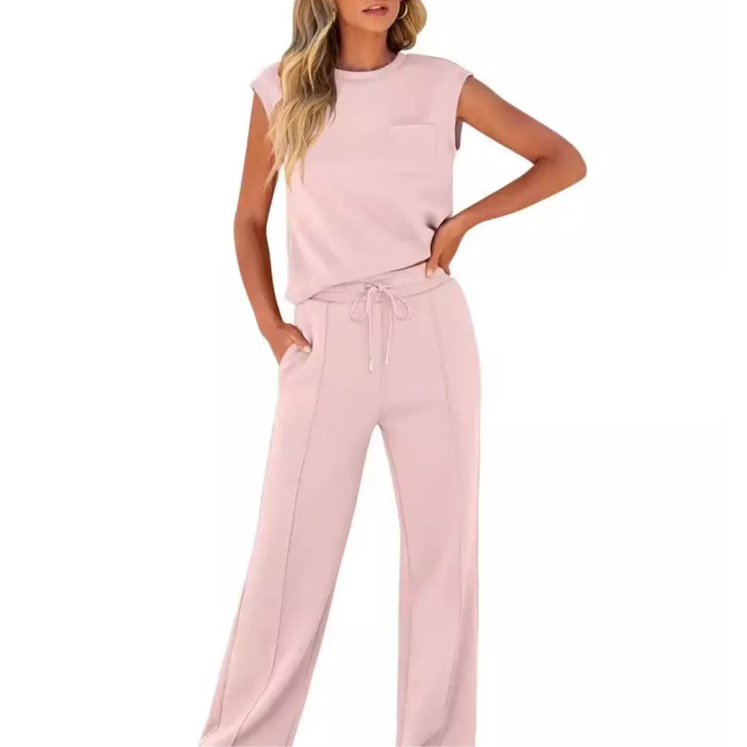 Pink cap sleeve matching two-piece trouser set on standing model