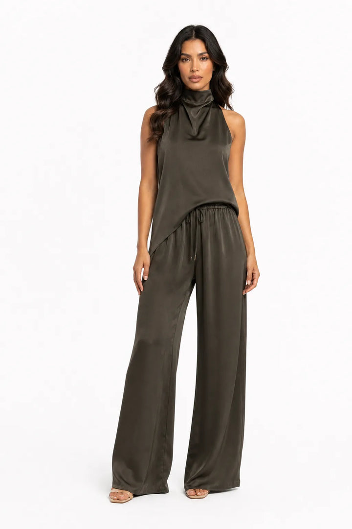 Black halter top and wide-leg trouser set on model in contrapposto stance