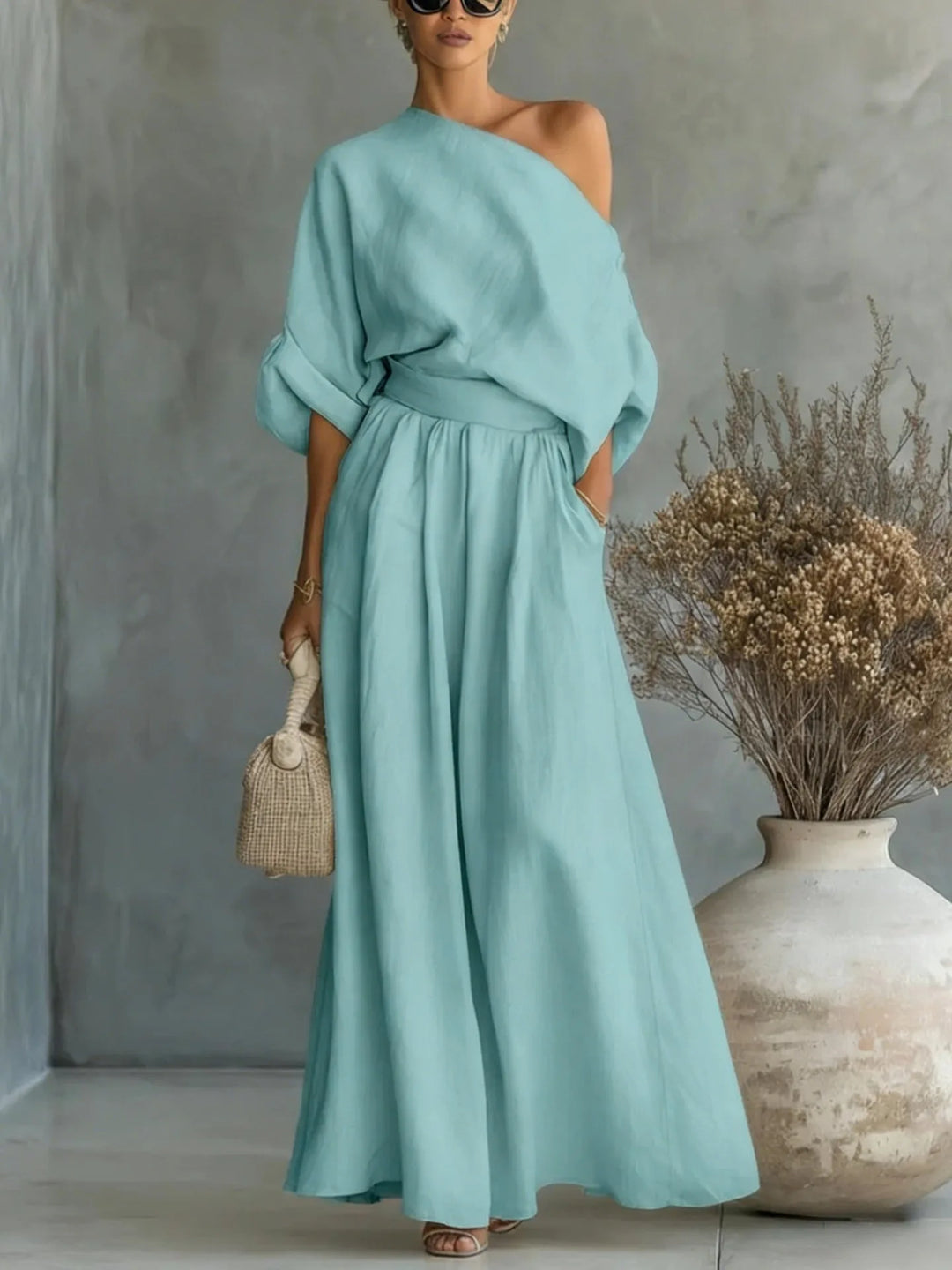 Blue off-shoulder crop top and wide-leg trouser set on standing model