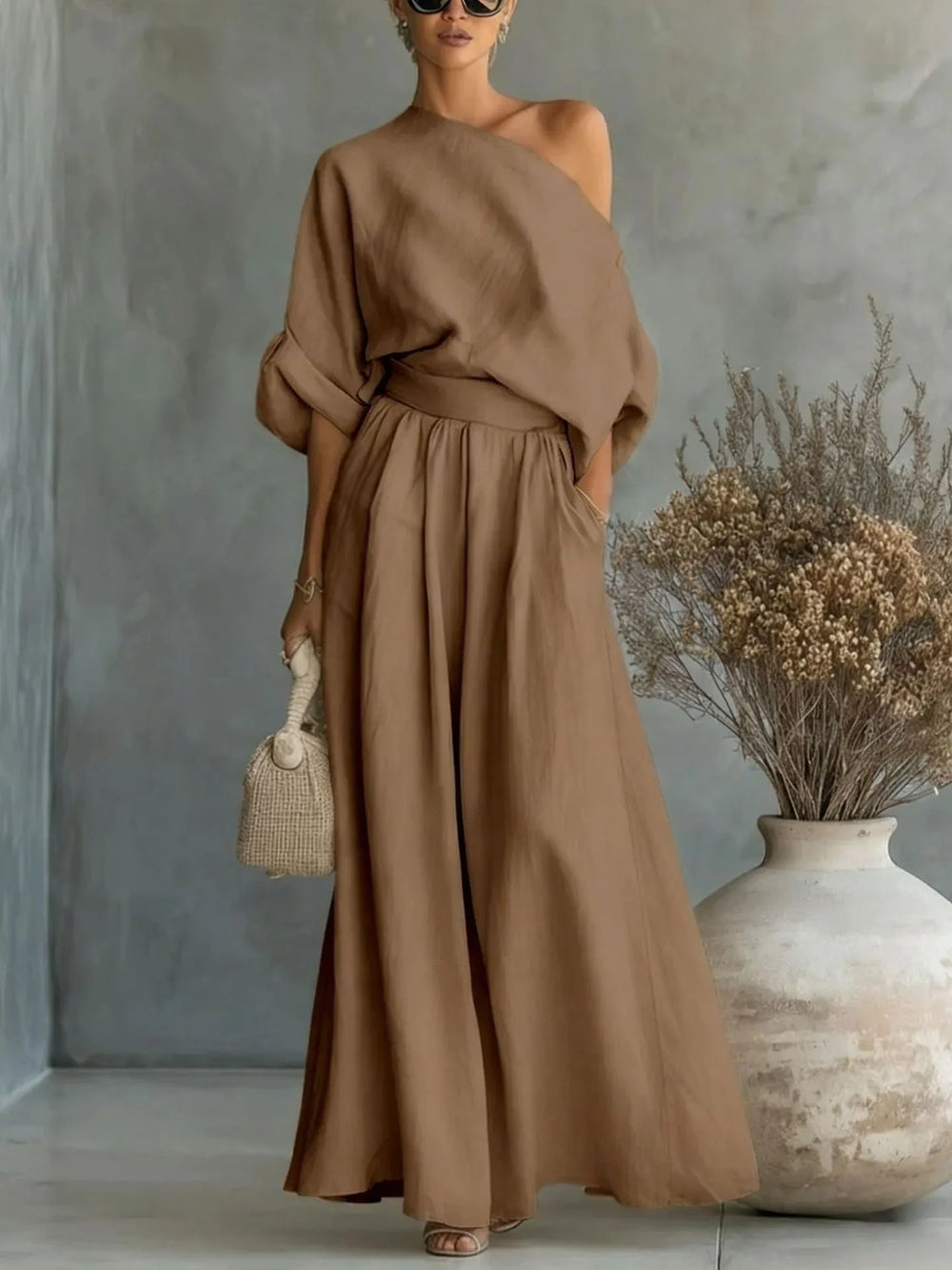 Close-up detail of brown off-shoulder crop top and wide-leg trouser set